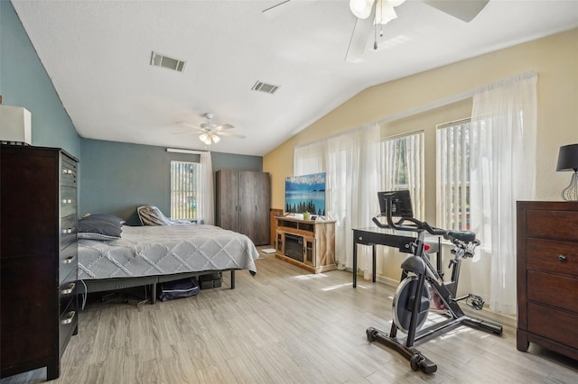 bedroom featuring lofted ceiling, visible vents, and light wood finished floors