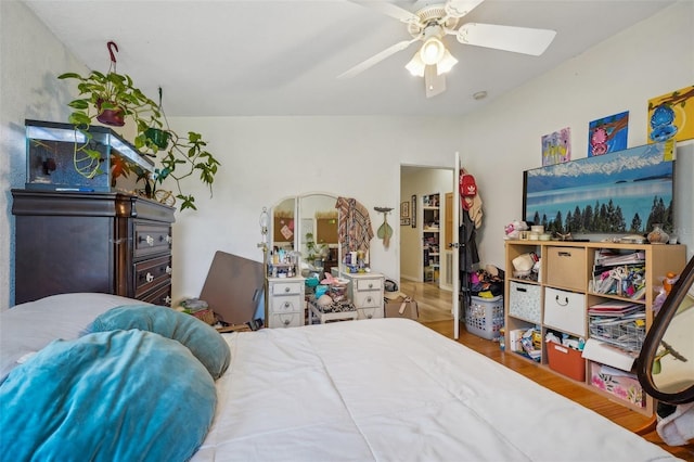 bedroom with vaulted ceiling, ceiling fan, and wood finished floors