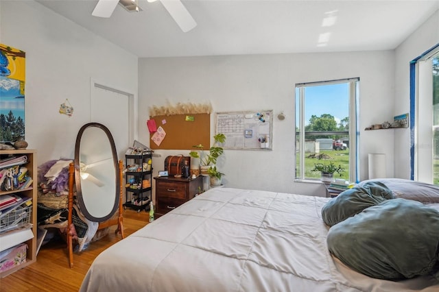 bedroom with a ceiling fan and wood finished floors