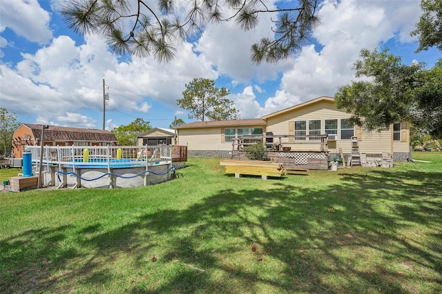 view of yard with a deck and an outdoor pool