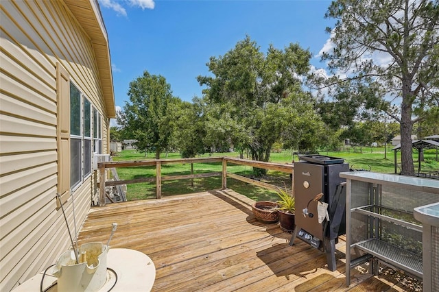 wooden terrace with a lawn