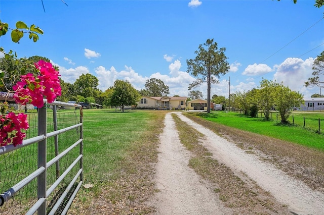 view of street featuring driveway and a gated entry