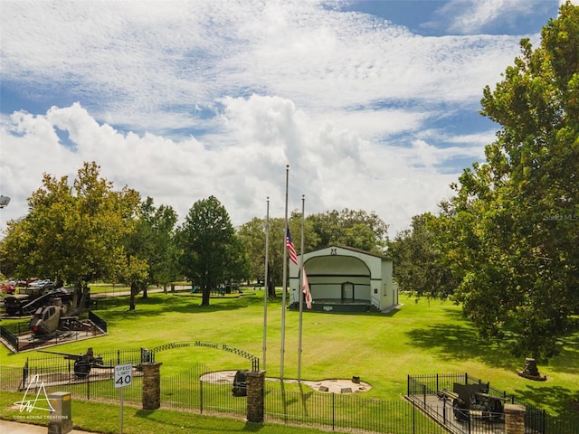 surrounding community featuring a carport, a yard, and fence