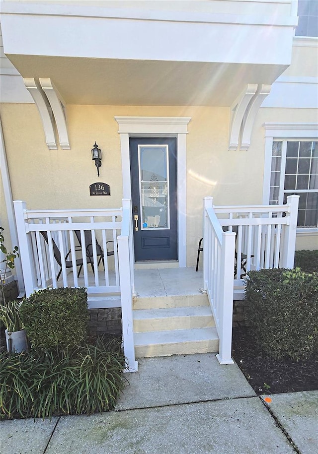 136 Mcleods Way, Winter Springs, FL 32708 - property entrance with a porch and stucco siding