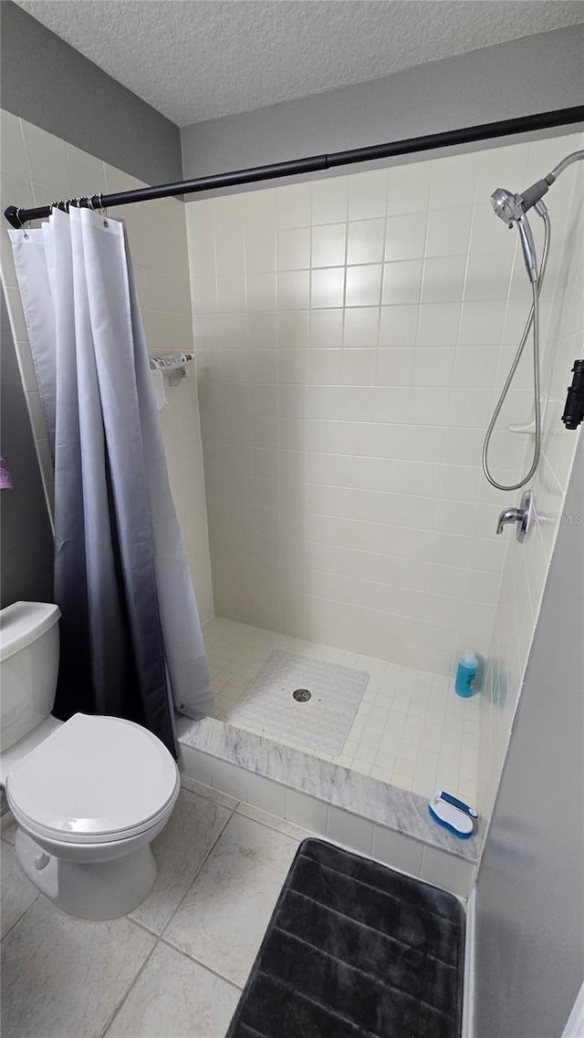 136 Mcleods Way, Winter Springs, FL 32708 - full bath with a stall shower, toilet, a textured ceiling, and tile patterned floors