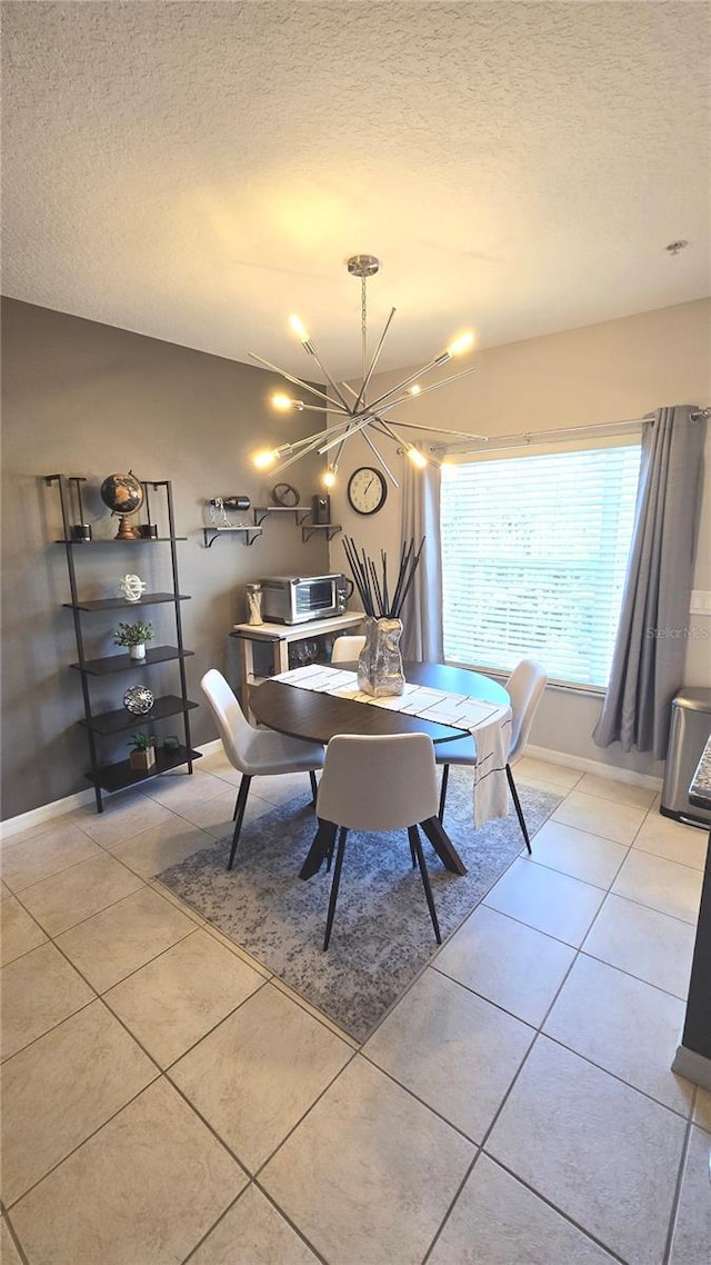 136 Mcleods Way, Winter Springs, FL 32708 - dining room featuring a textured ceiling, light tile patterned floors, a chandelier, and baseboards