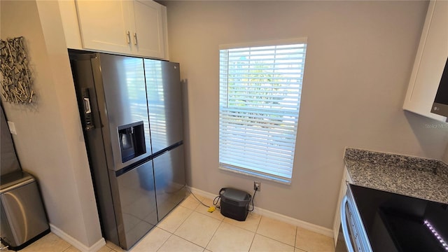 136 Mcleods Way, Winter Springs, FL 32708 - kitchen featuring stainless steel fridge, plenty of natural light, baseboards, and white cabinets
