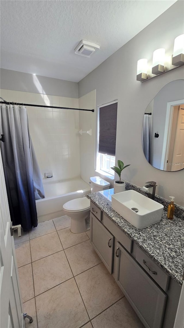 136 Mcleods Way, Winter Springs, FL 32708 - bathroom featuring toilet, a textured ceiling, vanity, tile patterned floors, and shower / bath combo with shower curtain