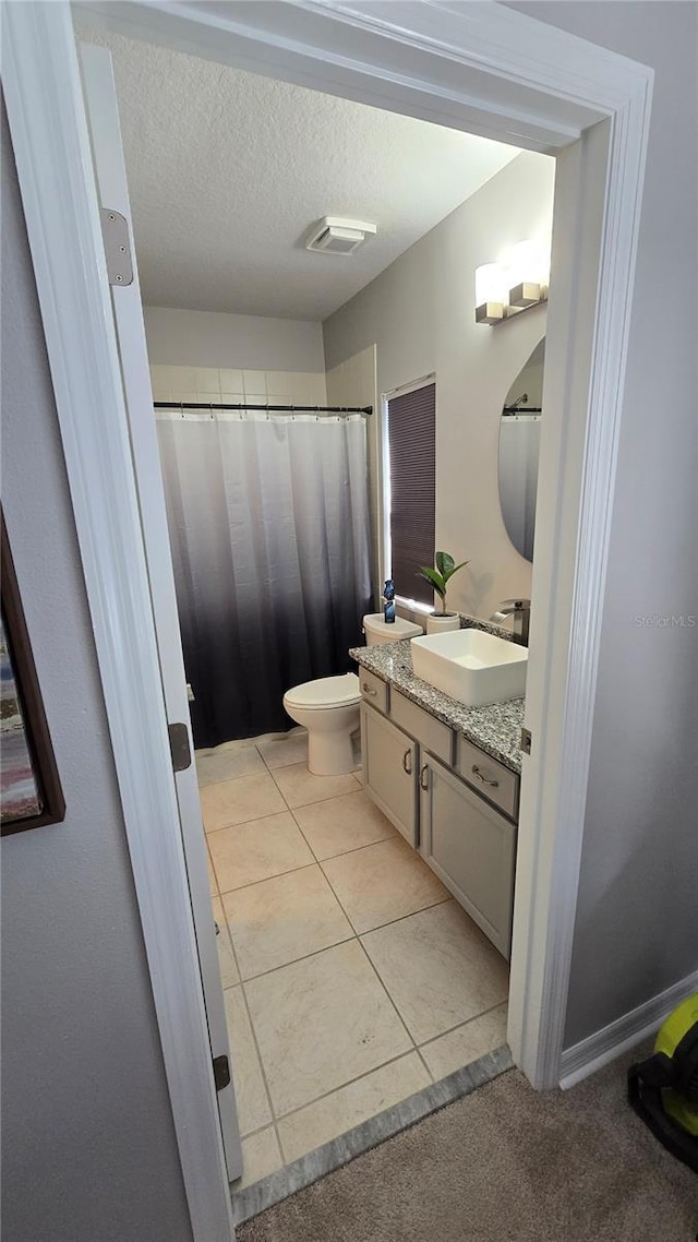 136 Mcleods Way, Winter Springs, FL 32708 - bathroom featuring vanity, toilet, a textured ceiling, a shower with curtain, and tile patterned flooring
