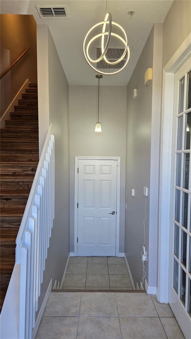 136 Mcleods Way, Winter Springs, FL 32708 - doorway to outside with tile patterned flooring, baseboards, stairway, and a towering ceiling