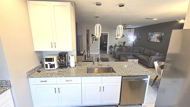 136 Mcleods Way, Winter Springs, FL 32708 - kitchen featuring stainless steel appliances, a sink, open floor plan, and white cabinets