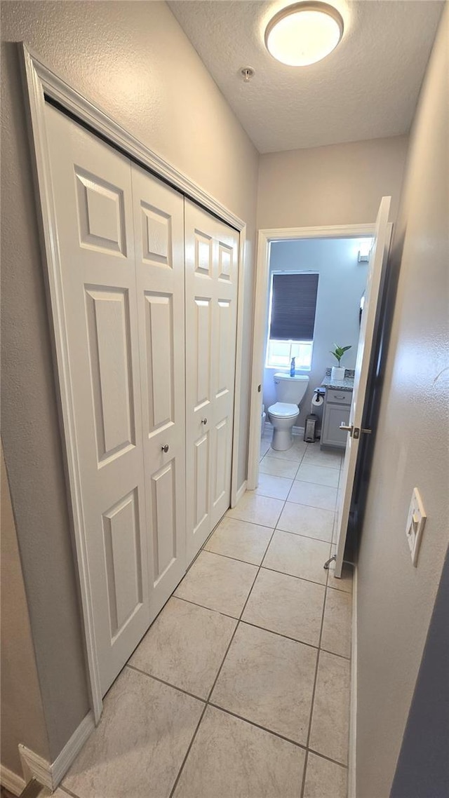 136 Mcleods Way, Winter Springs, FL 32708 - corridor featuring light tile patterned flooring, a textured ceiling, and baseboards