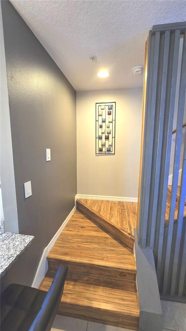 136 Mcleods Way, Winter Springs, FL 32708 - stairway featuring a textured ceiling, baseboards, and recessed lighting