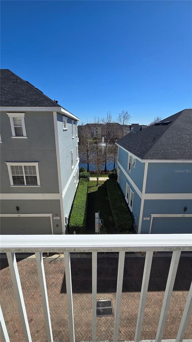 136 Mcleods Way, Winter Springs, FL 32708 - view of home's exterior featuring stucco siding, a balcony, a water view, and roof with shingles