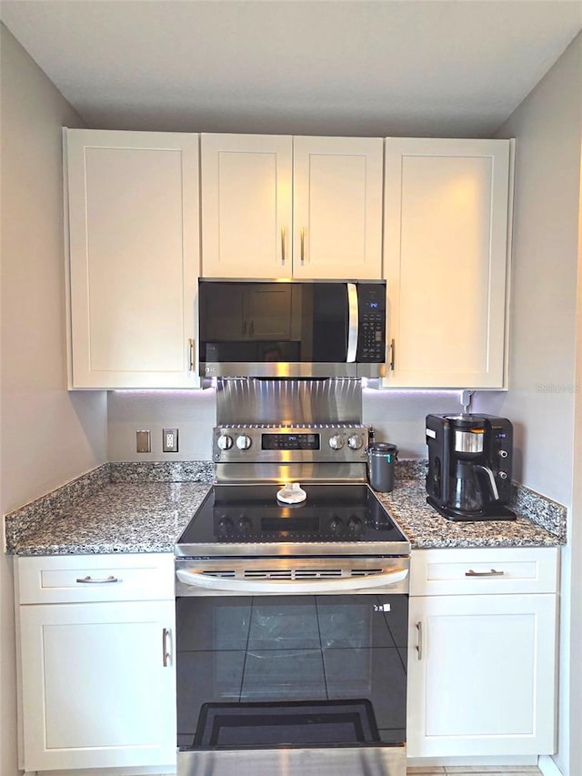 136 Mcleods Way, Winter Springs, FL 32708 - kitchen with appliances with stainless steel finishes, white cabinets, and stone countertops