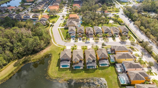 drone / aerial view featuring a water view and a residential view