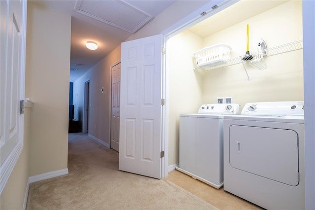 laundry area with baseboards, laundry area, separate washer and dryer, and light colored carpet