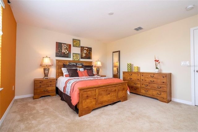 bedroom with light carpet, visible vents, and baseboards