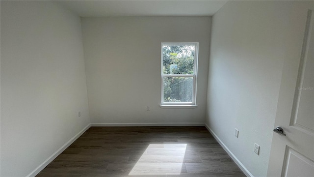 empty room featuring dark hardwood / wood-style flooring