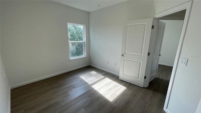 empty room featuring dark hardwood / wood-style floors