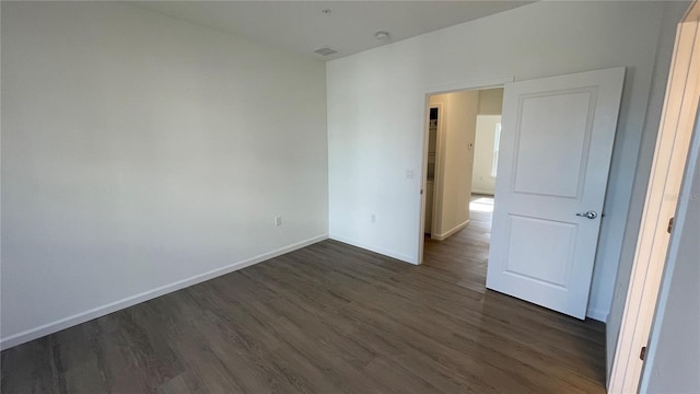 unfurnished bedroom featuring dark hardwood / wood-style flooring