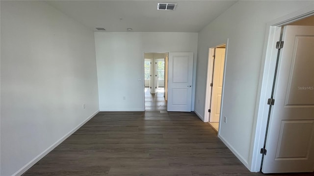 hallway with dark hardwood / wood-style flooring