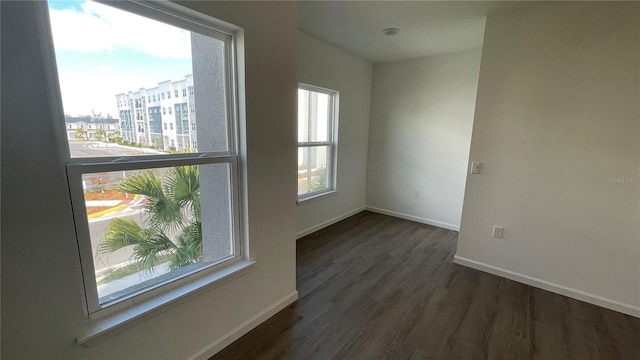 unfurnished room featuring dark hardwood / wood-style floors