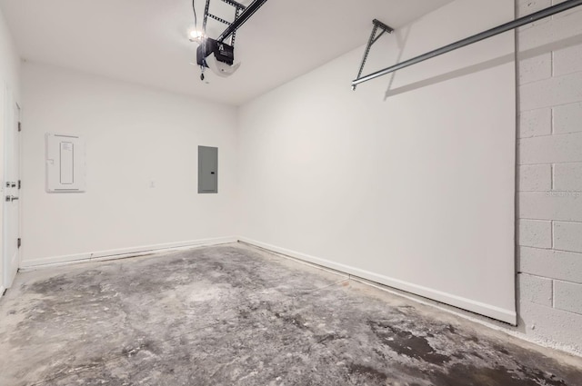 garage with concrete block wall, electric panel, and a garage door opener