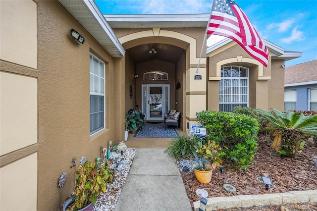 doorway to property with stucco siding