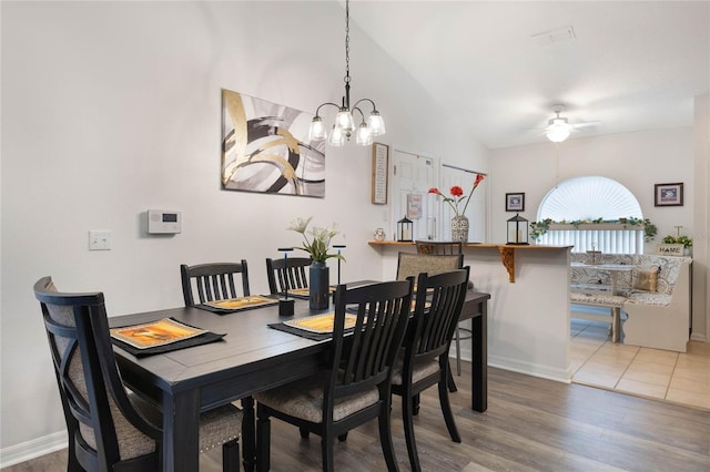 130 Bloomingdale Dr, Davenport, FL 33897 - dining area featuring ceiling fan, lofted ceiling, wood finished floors, a chandelier, and baseboards