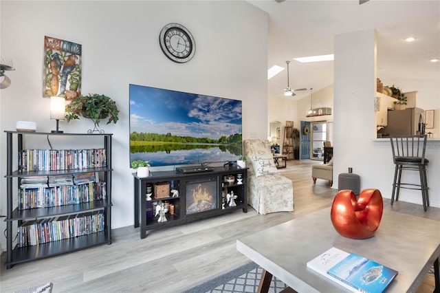 130 Bloomingdale Dr, Davenport, FL 33897 - living area with wood finished floors, a ceiling fan, arched walkways, and a towering ceiling