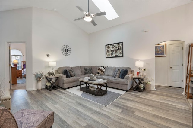 130 Bloomingdale Dr, Davenport, FL 33897 - living room featuring light wood-type flooring, high vaulted ceiling, a ceiling fan, a skylight, and baseboards