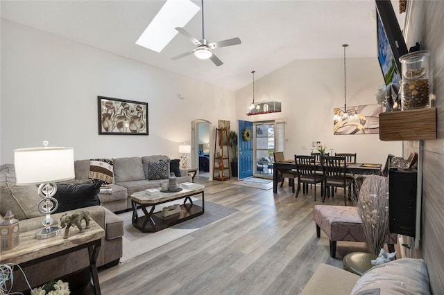 130 Bloomingdale Dr, Davenport, FL 33897 - living room featuring arched walkways, a chandelier, wood finished floors, ceiling fan, and high vaulted ceiling