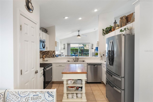 130 Bloomingdale Dr, Davenport, FL 33897 - kitchen with appliances with stainless steel finishes, a sink, open shelves, vaulted ceiling, and white cabinetry