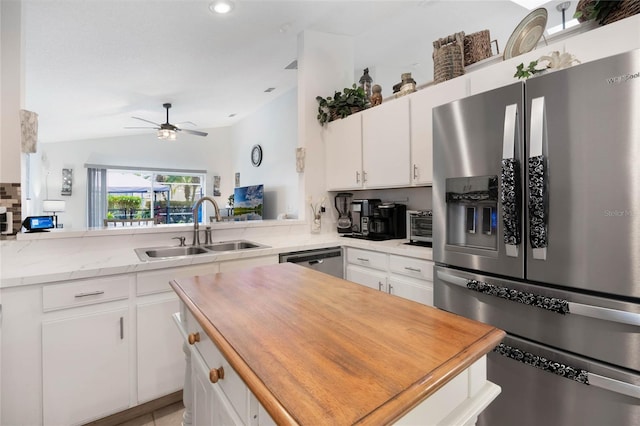 130 Bloomingdale Dr, Davenport, FL 33897 - kitchen with stainless steel appliances, a sink, a kitchen island, a ceiling fan, and white cabinets