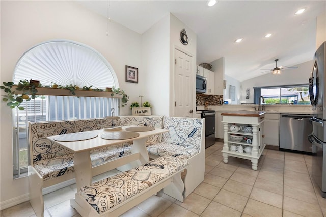 130 Bloomingdale Dr, Davenport, FL 33897 - dining space featuring breakfast area, ceiling fan, lofted ceiling, light tile patterned floors, and recessed lighting