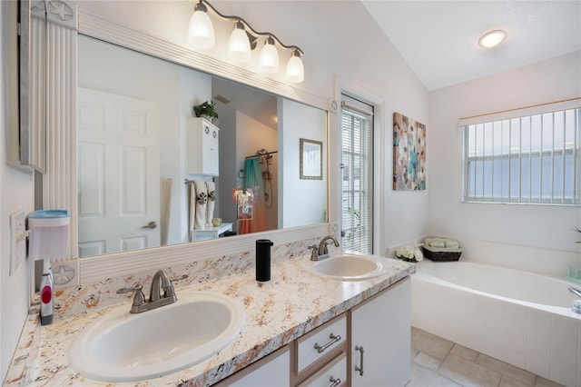 130 Bloomingdale Dr, Davenport, FL 33897 - full bathroom with a bath, double vanity, and lofted ceiling