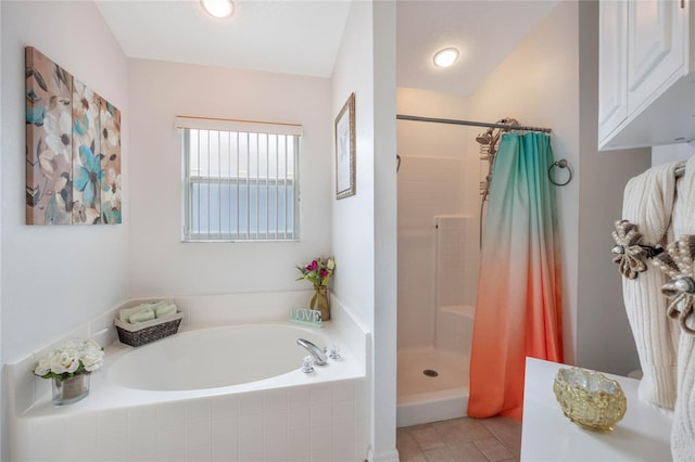 130 Bloomingdale Dr, Davenport, FL 33897 - full bath featuring a garden tub, a shower stall, and tile patterned floors