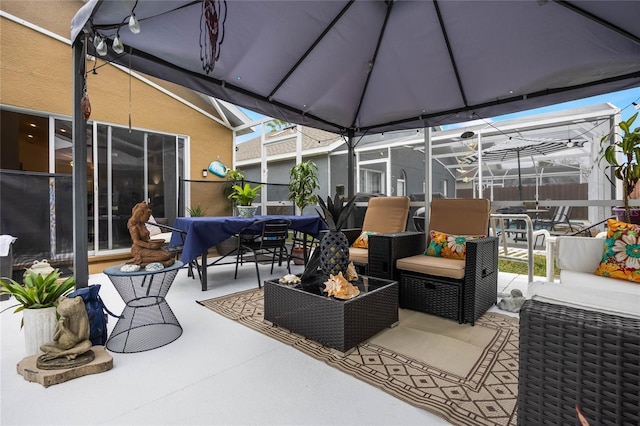 130 Bloomingdale Dr, Davenport, FL 33897 - view of patio featuring outdoor dining space, an outdoor living space with a fire pit, and glass enclosure