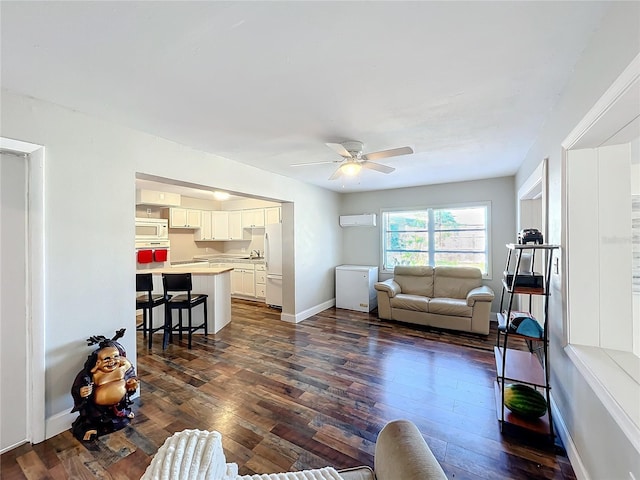 living room featuring a wall unit AC, ceiling fan, and dark hardwood / wood-style flooring