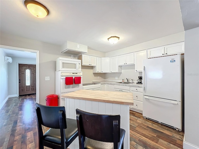 kitchen featuring white appliances, sink, wooden counters, dark wood-type flooring, and white cabinets