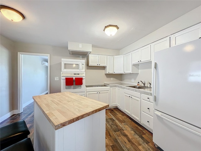 kitchen with white appliances, sink, white cabinets, and butcher block countertops