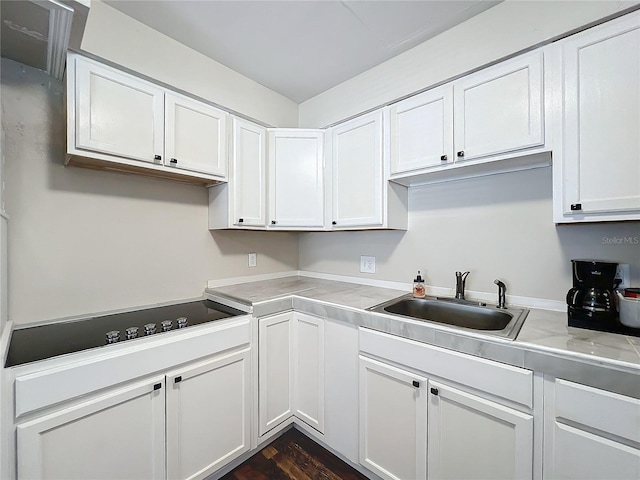 kitchen featuring white cabinetry and sink