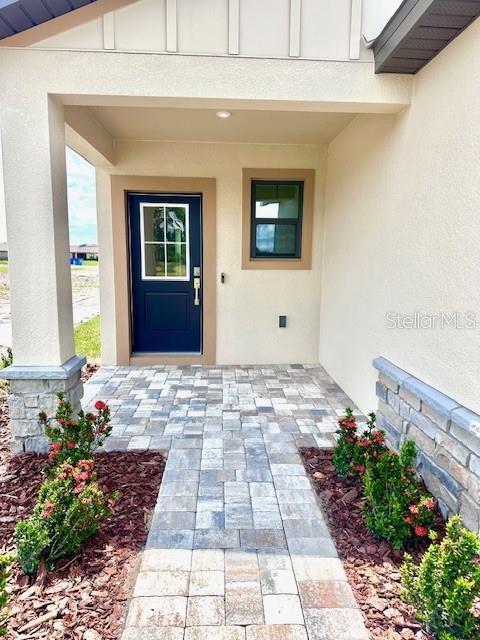 3225 Cup Dr, Lakeland, FL 33803 - view of exterior entry with stucco siding