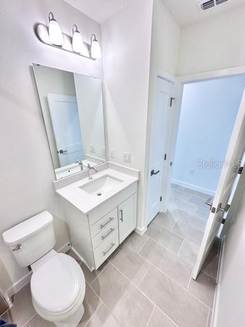 3225 Cup Dr, Lakeland, FL 33803 - bathroom featuring toilet, vanity, and tile patterned flooring