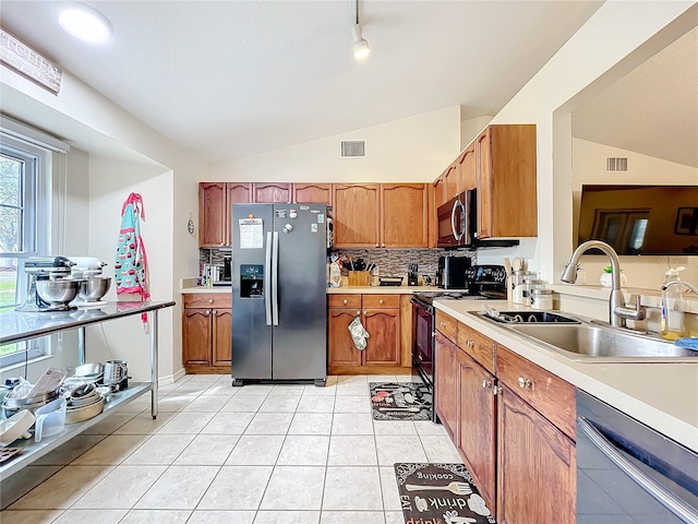 kitchen with visible vents, appliances with stainless steel finishes, vaulted ceiling, and light countertops