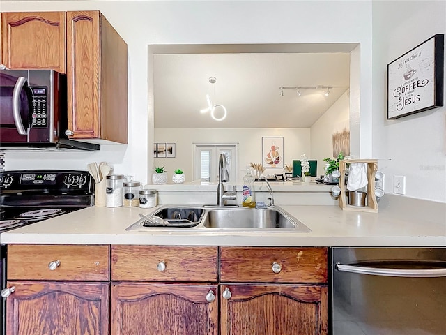 kitchen with light countertops, appliances with stainless steel finishes, brown cabinetry, and a sink