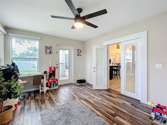 office with wood finished floors, a ceiling fan, and baseboards