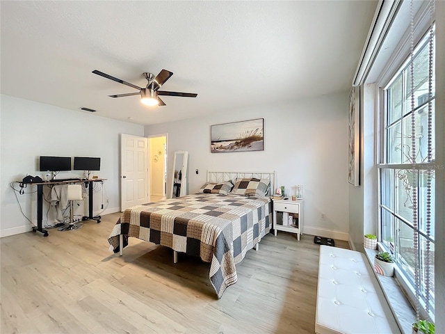 bedroom with light wood finished floors, baseboards, and visible vents