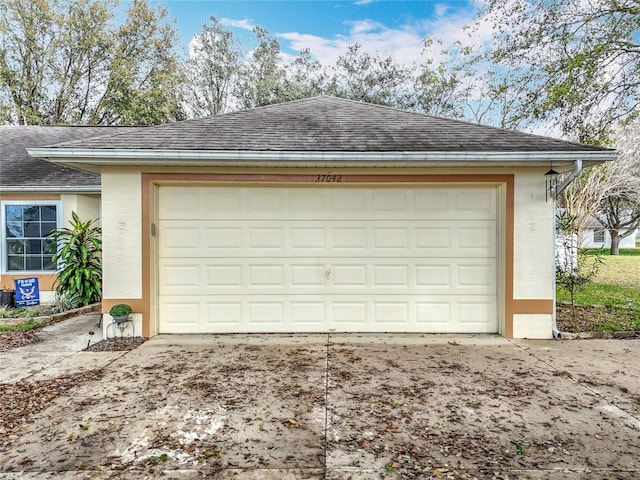 garage with concrete driveway